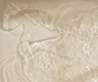 Close-up of Bare Mum Sitz bath salts dissolved into bath of water. 