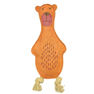 Baz the Bear Dog Toy in Orange. He has a black nose, black crosses for eyes, a black mouth and a pink circle that spans from the top of his nose to just underneath his mouth. He has threads on his stomach that resemble dark hair and two small cord legs. His arms are not separate like the legs, they are made from the same material as his body and face. He is pictured on a white background.