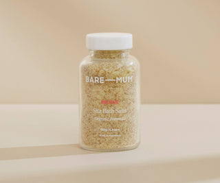 Bottle of Bare Mum Sitz Bath Salts on a beige background.